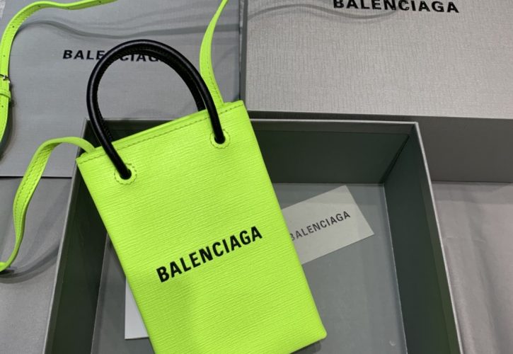 Balenciagas Fluo Green Phone Pouch Tote Takes Center Stage at Fashion Events